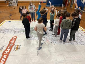 Kids on the map trying to find the state's that they were given