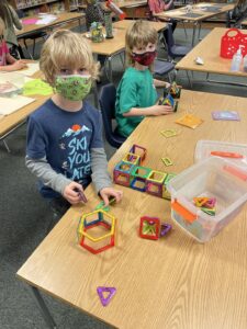 Student working with magnet tiles