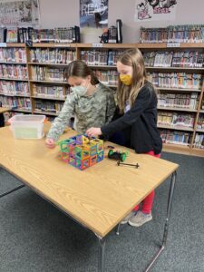Students building with magnet tiles