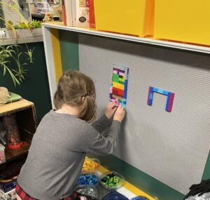 Student working on the lego wall