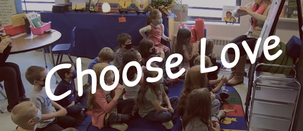 students in class with Choose Love