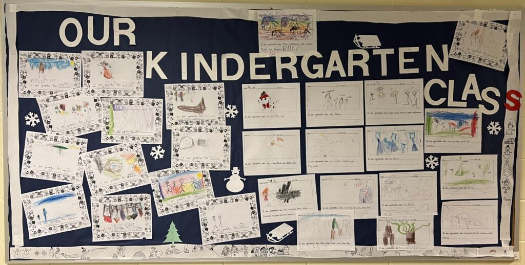 Kindergarten students writing samples on their bulletin board