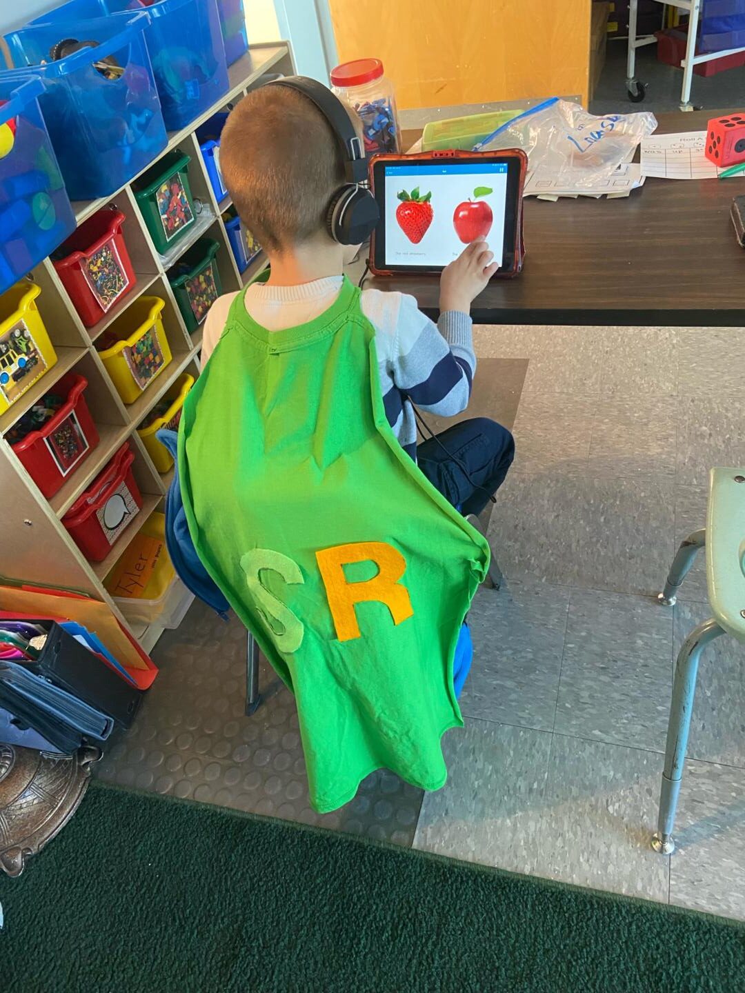 Kindergarten student reading on his iPad