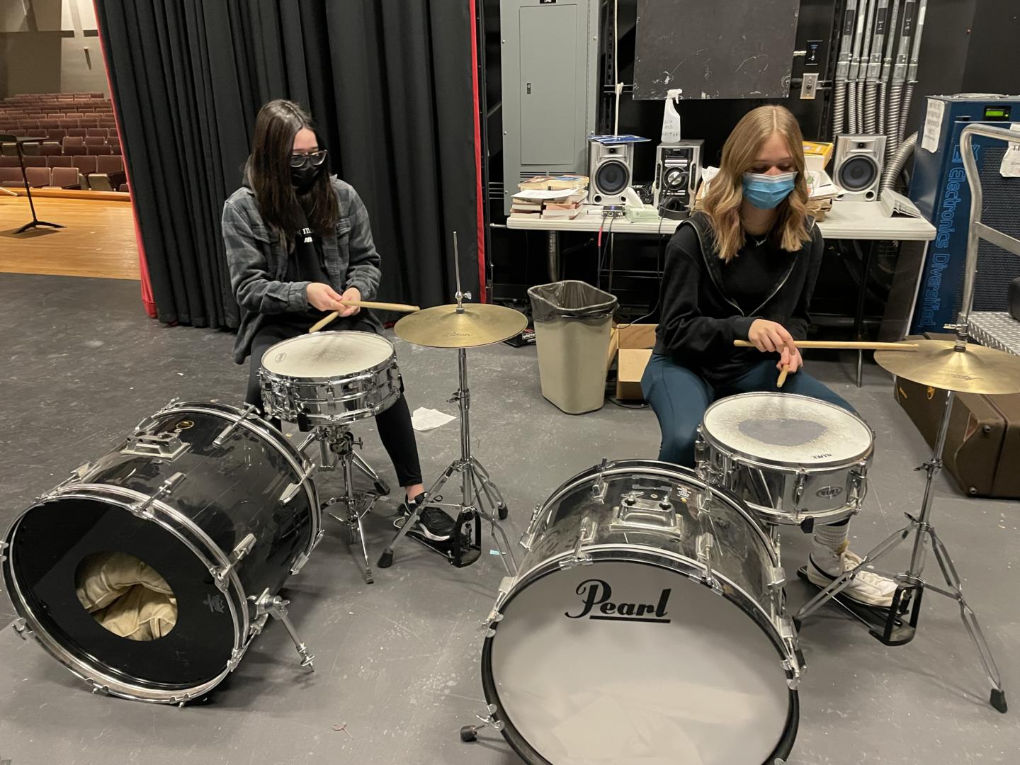 Two students playing drumset