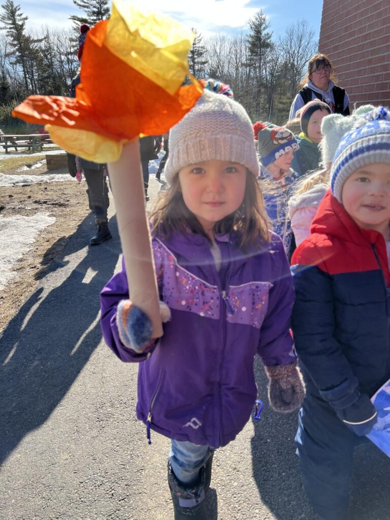 Preschool student holding torch