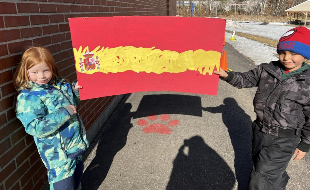 Kindergarten students holding their flag