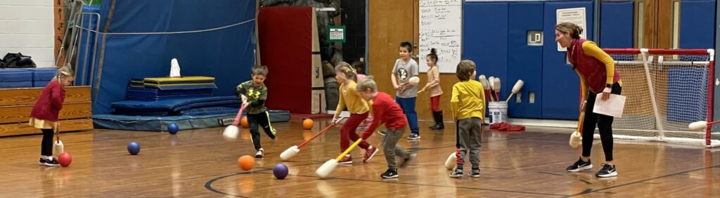 students playing floor hockey