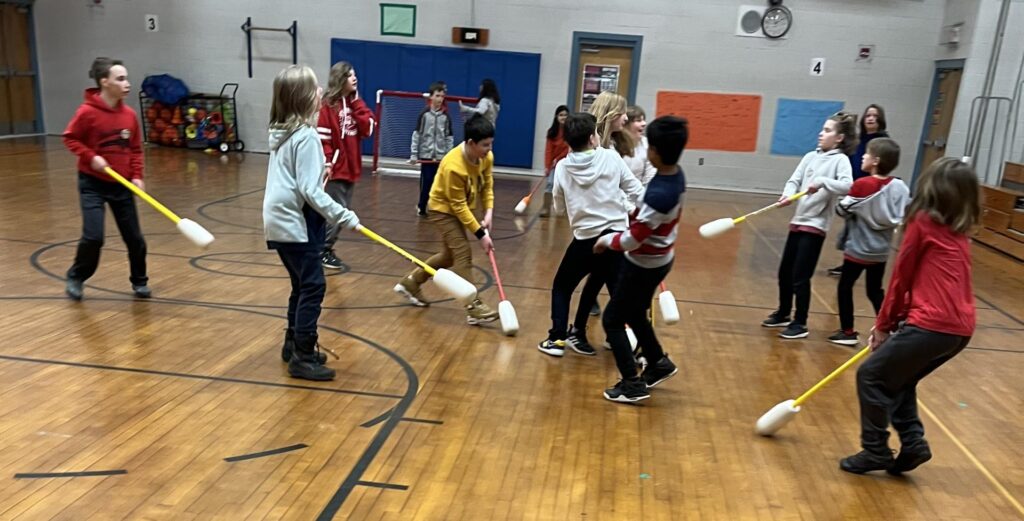 students playing floor hockey