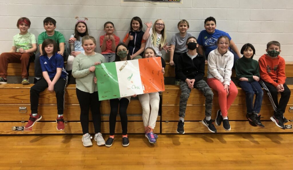 students holding their team flag