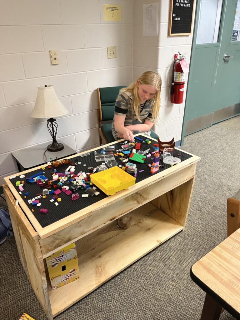 Student with new table made by Tech Ed