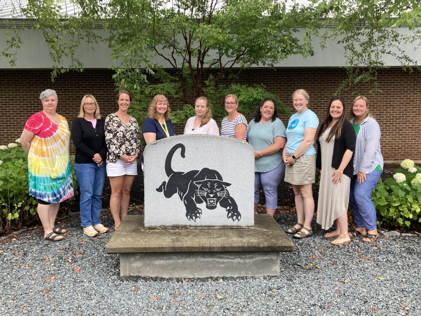 teachers standing by sign