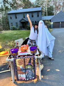 HS student volunteer handing out candy