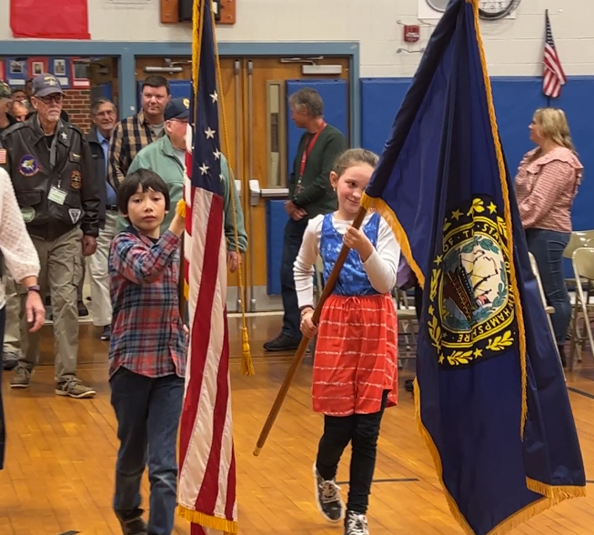 students carrying in the United States and New Hampshire flags
