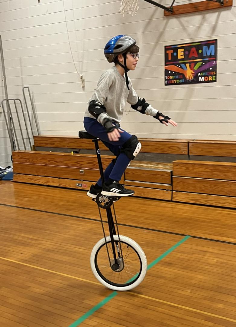 student on a unicycle