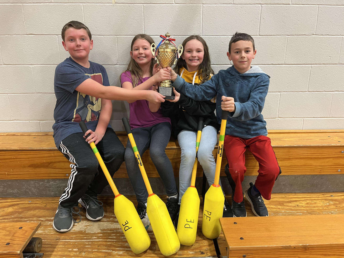 students holding their trophy after winning Pillo Pollo Championship