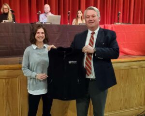 woman receiving vest from man