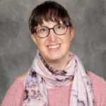 woman with glasses smiling