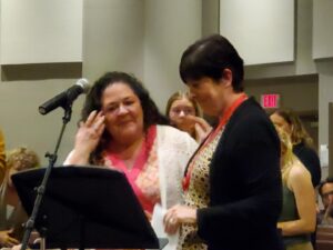 2 women at the podium.