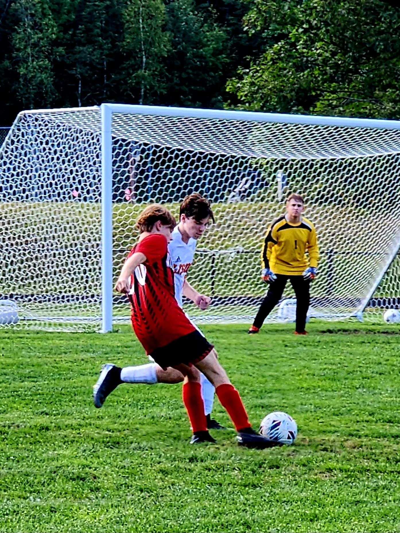 soccer player kicking ball