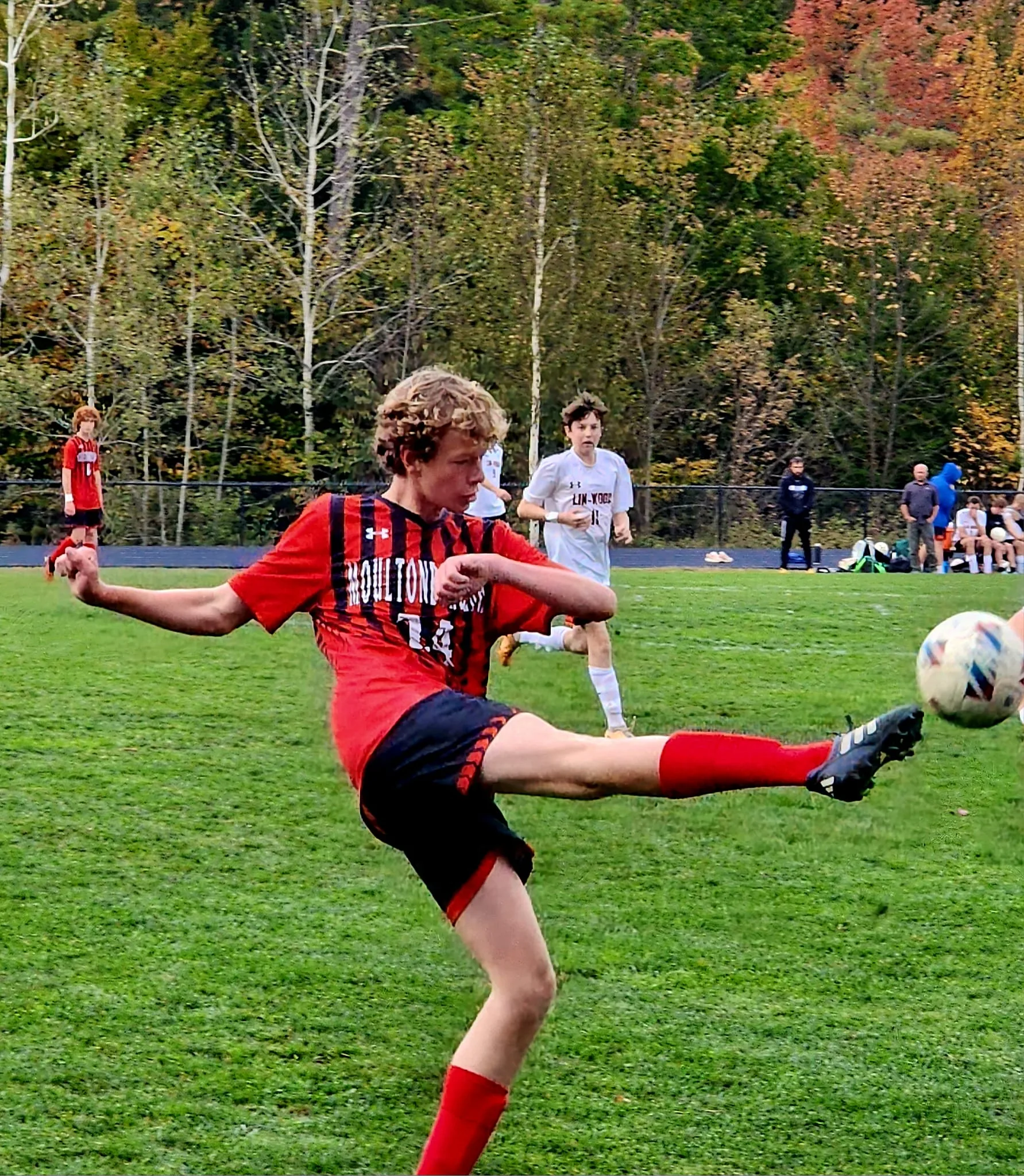 soccer player kicking soccer ball