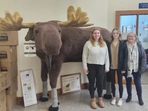 3 women with stuffed moose