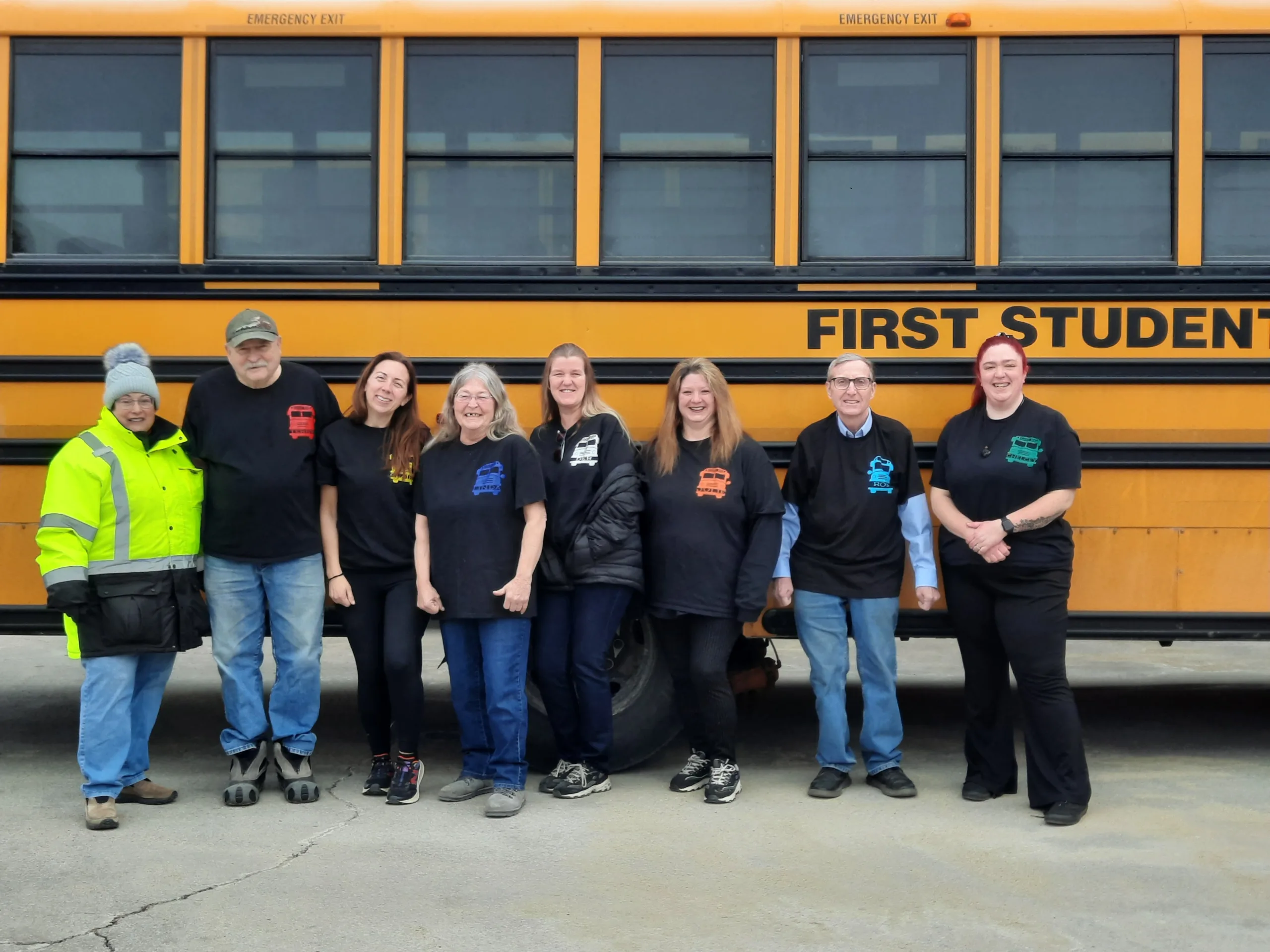 bus drivers standing in front of bus
