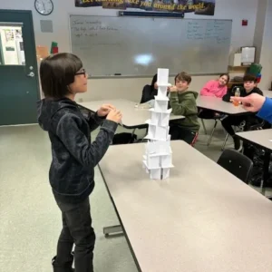 boy building paper tower