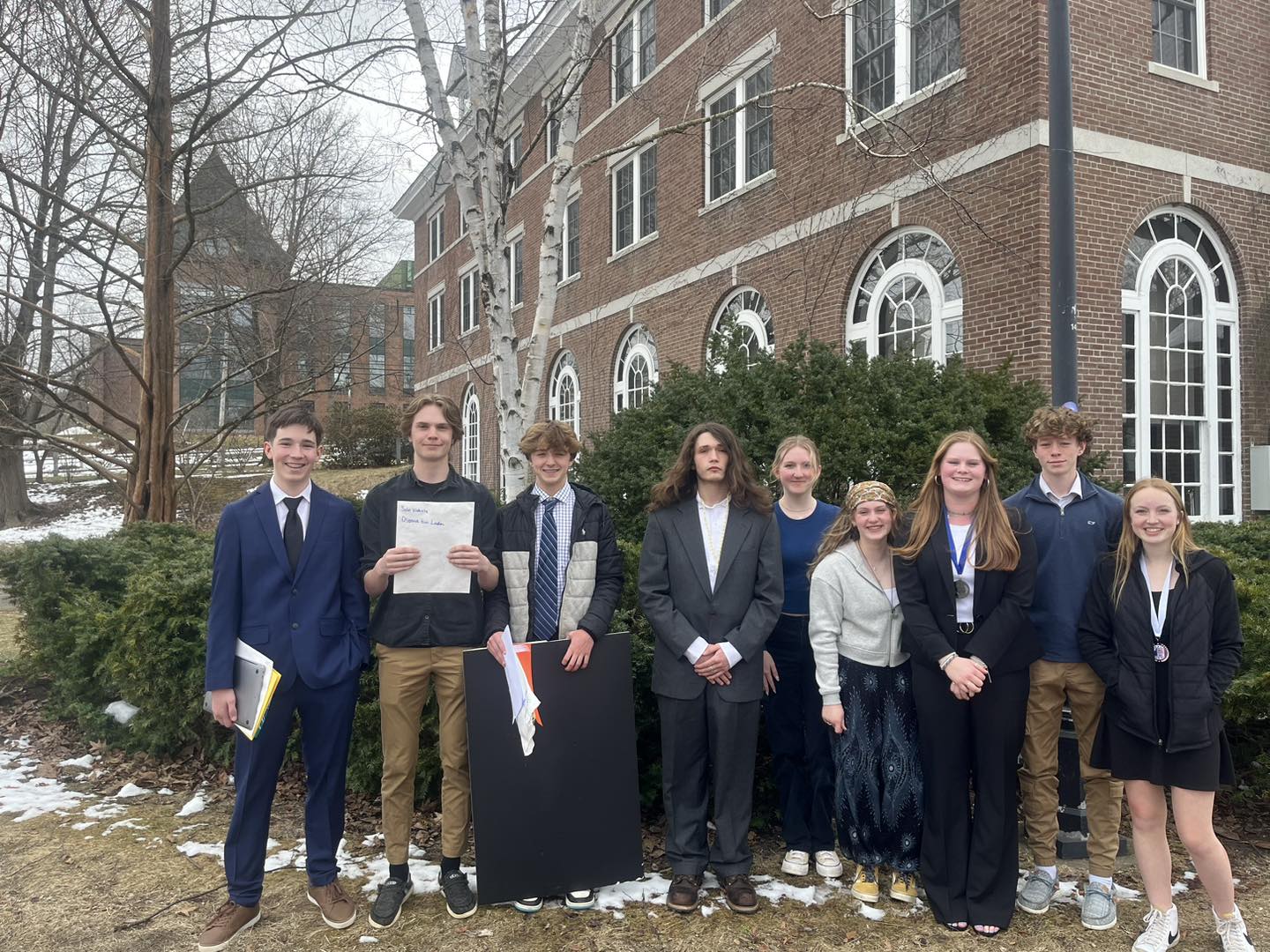 group of students standing together outside of building