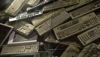 computer keyboards and screens piled up