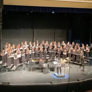 students standing on rising during a choral concert