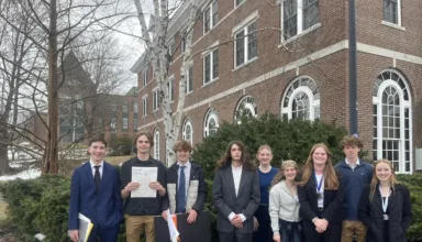 group of students standing together outside of building